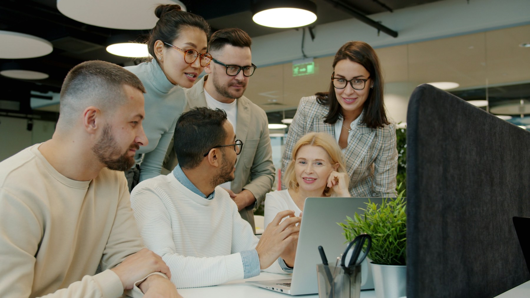 Fictional Mecilo team reviewing product concepts together in a bright studio